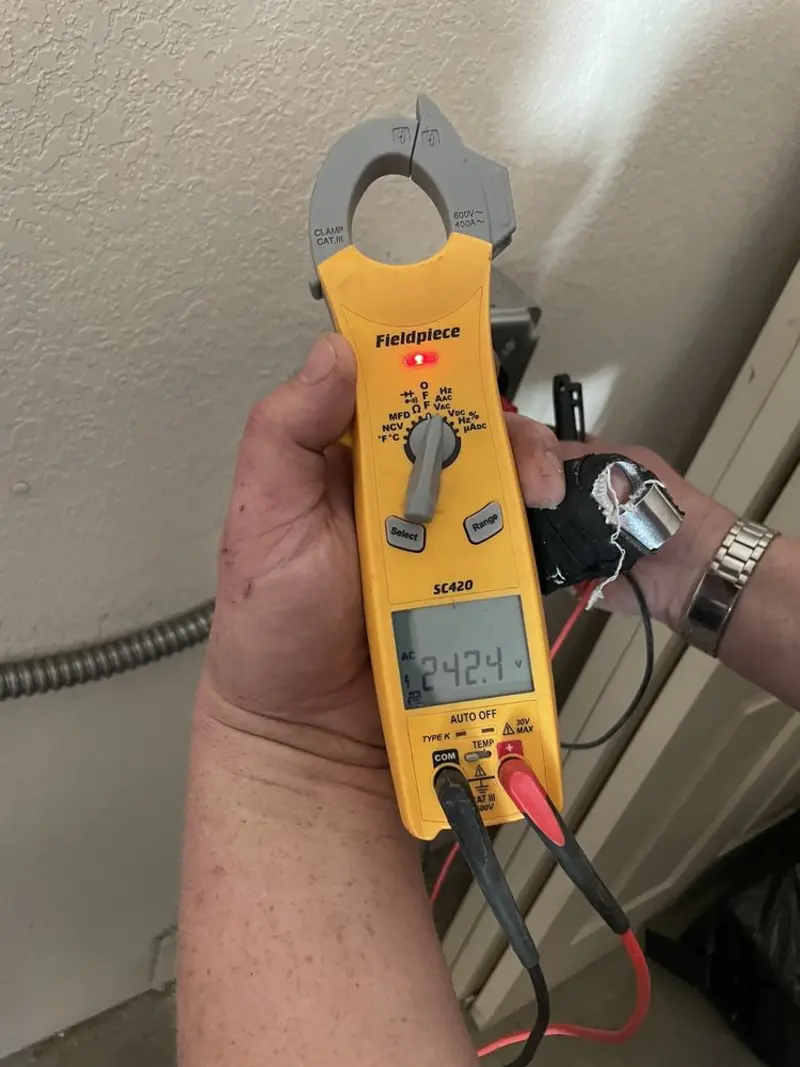 Voltage testing with clamp meter during Recessed Lighting Installation in Etowah
